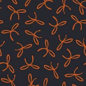 Freehand bows in polka dot style design - bright orange on black background