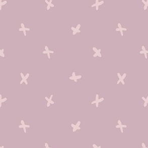 Hand-drawn playful cross in polka dot style - lilac on puce pink background