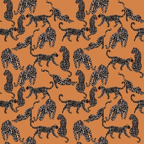 Modern black leopards in sandal brown background 