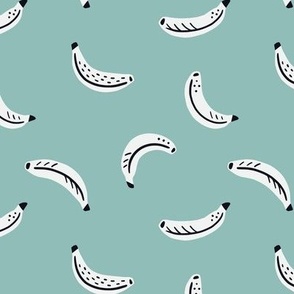 White graphic bananas on green background - scattered tropical fruits