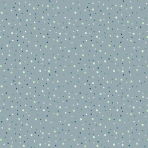 Polka dot pattern. Small white, blue, green peas on a gray background.