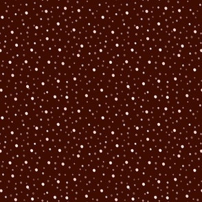 Polka dot pattern. Small white, beige polka dots on a brown background.