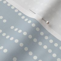 Vertical wavy lines of dots in a subtle nod to bubbles rising on a light blue background