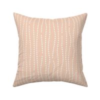 Vertical wavy lines of dots in a subtle nod to bubbles rising on a peachy orange background
