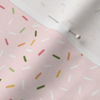 Cupcake sprinkles in white, pink, and green on pastel pink | small