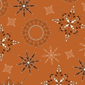 Delicate snow flakes in different sizes toss print - white and dark brown on burnt orange background 