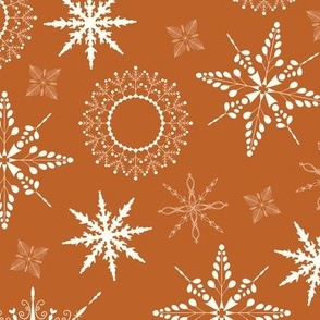 Delicate snow flakes in different sizes toss print - white on burnt orange background 