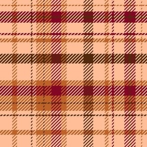 Christmas plaid in peach fuzz, burnt orange, dark brown and cranberry red