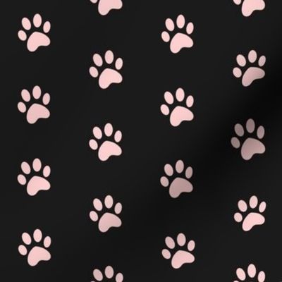 simple pastel pink cat paw prints on black 