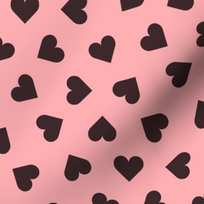 dark chocolate hearts on pink