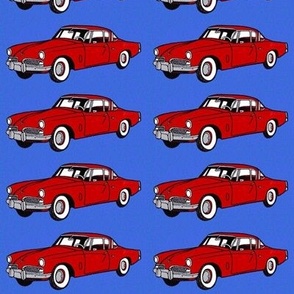 Red 1954 Studebaker 2 door on blue background