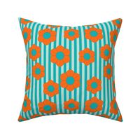 Bright orange flowers on light and dark turquoise stripes evoke a fun, retro vibe with a graphic twist.