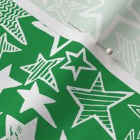White patterned stars on green background