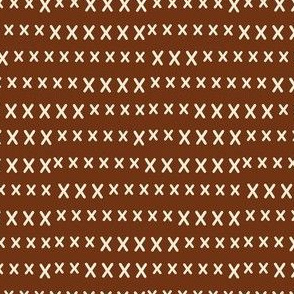 hand cross stitch on brown