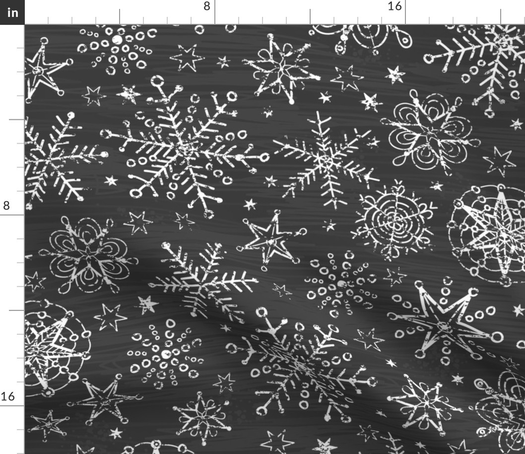 Chalk snowflakes on blackboard