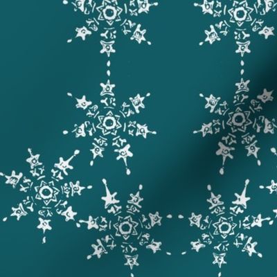 snowflake arrangemet on teal blue sky