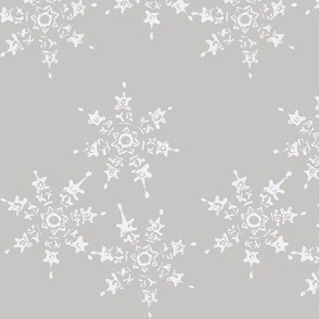 snowflake flurry on grey winter sky