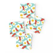 Fried egg and bacon pattern. Breakfast food design. Blue background.