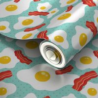 Fried egg and bacon pattern. Breakfast food design. Blue background.