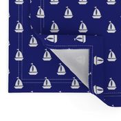 Small White Sailboats on Blue