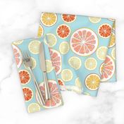 Grapefruit love - lemon, orange and grapefruit slices on blue background 