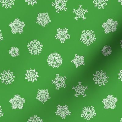 cut paper snow stars on Christmascolors green