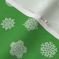 cut paper snow stars on Christmascolors green