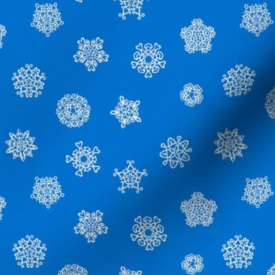 cut-paper snow stars on Christmascolors blue