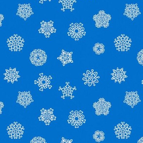 cut-paper snow stars on Christmascolors blue