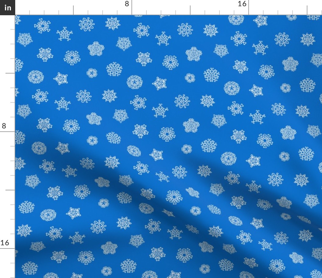 cut-paper snow stars on Christmascolors blue