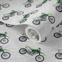 Green Dirt Bike with grey dirt background