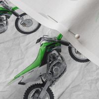 Green Dirt Bike with grey dirt background