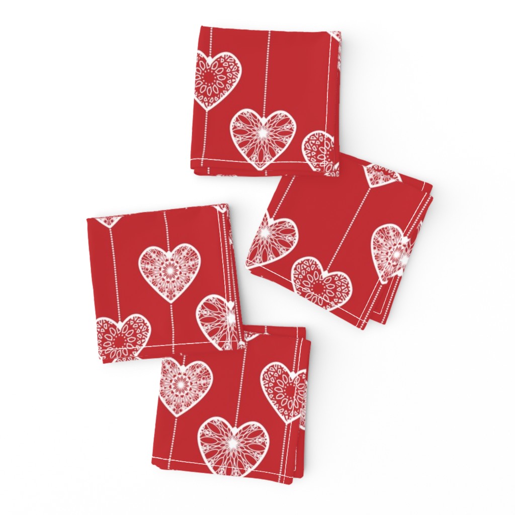 White lace hearts on a red background, a romantic and festive pattern.