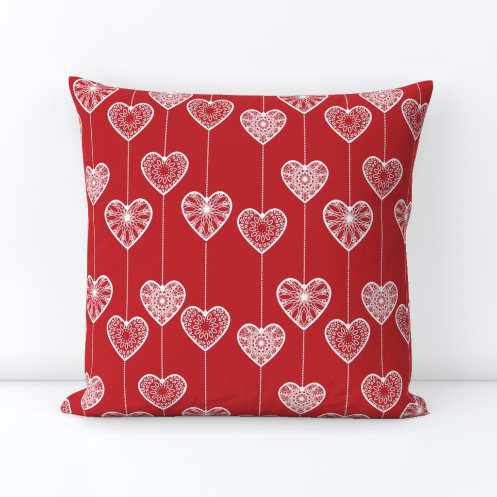 White lace hearts on a red background, a romantic and festive pattern.