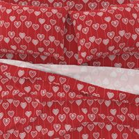 White lace hearts on a red background, a romantic and festive pattern.