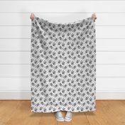 Trotting Keeshond and paw prints - white
