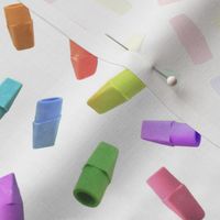 colorful pencil eraser caps on white