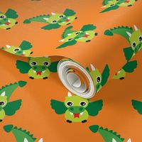 Cute little dragon fantasy dinosaur kids illustration in orange and green