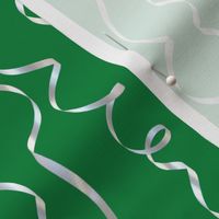 white curling ribbons on green