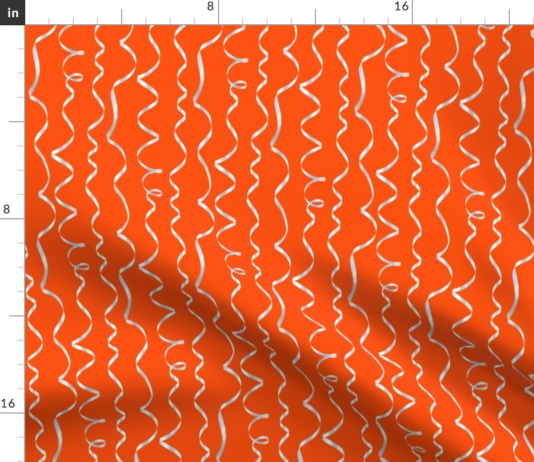 white curling ribbons on red-orange