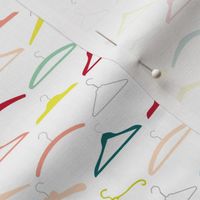 Colourful vintage coathangers on white