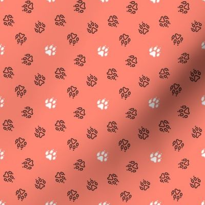 Trotting paw prints - black on coral with white