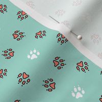 Trotting paw prints - coral on mint