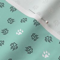 Trotting paw prints - black on mint with white