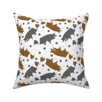 Trotting Border Collies and paw prints - white