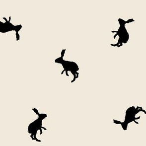 Rabbit Silhouettes on Sand Background