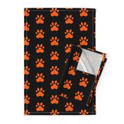 Pawprint Polka dots - 1 inch (2.54cm) - Mid Orange (#FF5F00) on Black (#000000)