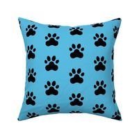 Pawprint Polka dots - 1 inch (2.54cm) - Black (#000000) on Pale Blue (#57BEE4)