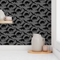 dinosaurs in black on charcoal grey