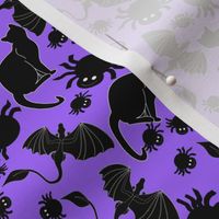 tossed black cats and spiders on purple